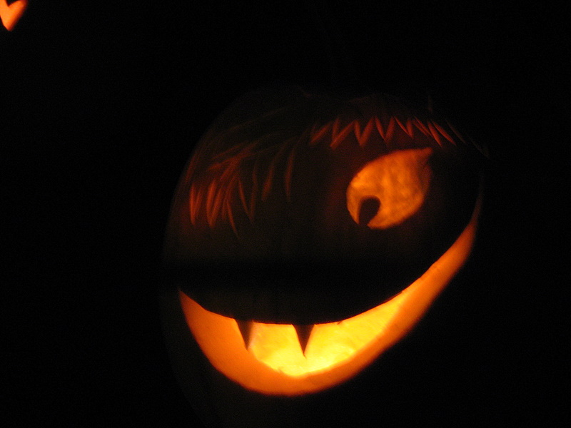 a jack o'lantern carved to look like a vampire