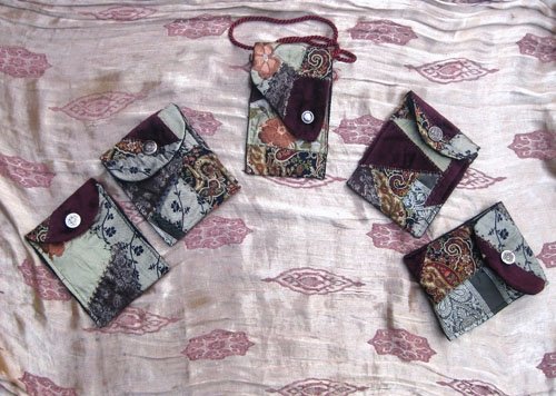 Five small crazy-quilted wallets.