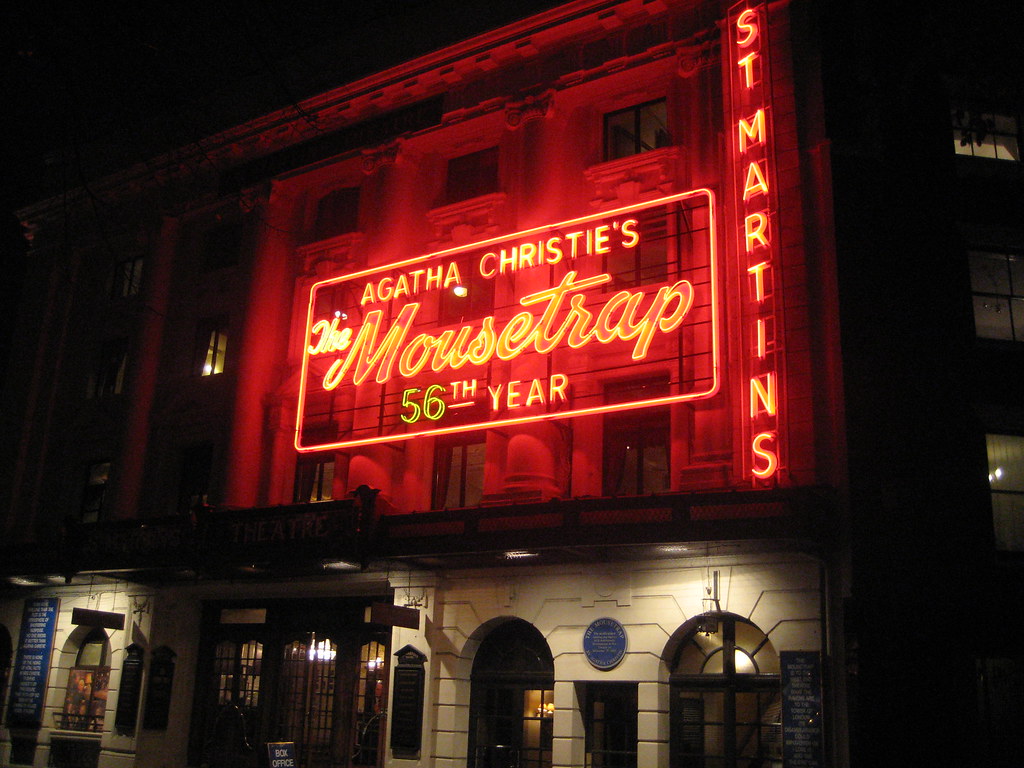 A billboard reading "Agatha Christie's 'The Mousetrap' 56th year."