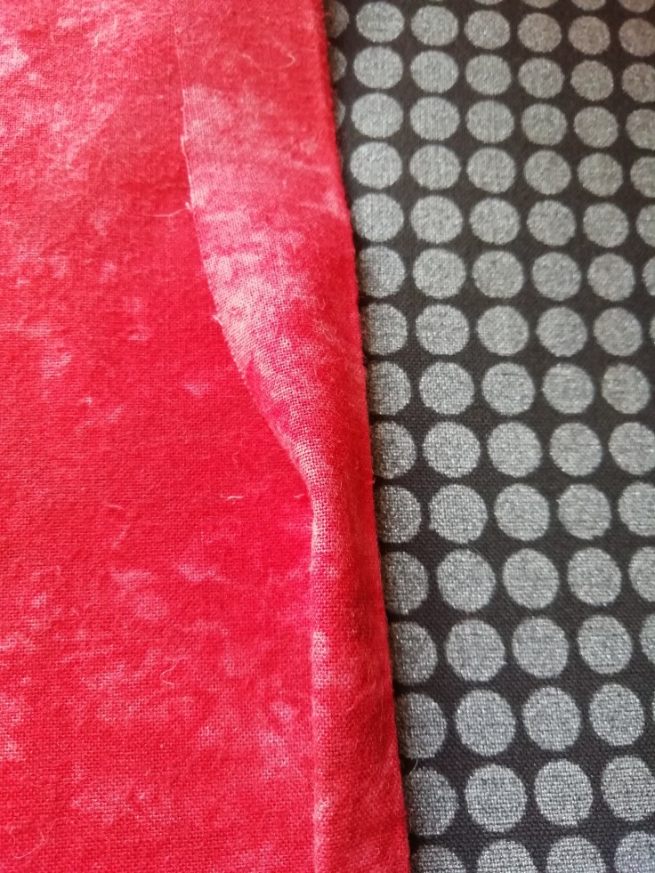 The hem is folded at half an inch, pressed, then folded over and pressed again.